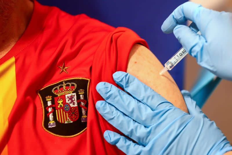 FILE PHOTO: Man receives his first dose of the AstraZeneca COVID-19 vaccine in Madrid