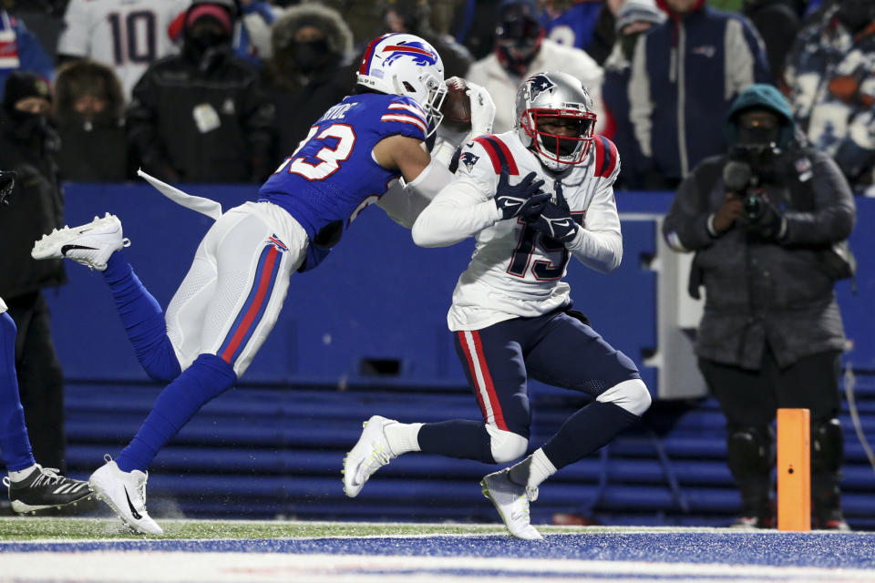 Buffalo Bills safety Micah Hyde (23) makes an interception against New England Patriots wide receiver Nelson Agholor (15) during the first half of an NFL wild-card playoff football game, Saturday, Jan. 15, 2022, in Orchard Park, N.Y. (AP Photo/Joshua Bessex)