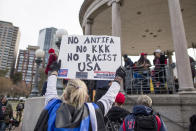 <p>A participant of an Alt-Right organized free speech event holds a sign that says “No Antifa, No KKK, No Racist USA” on the Boston Common on Nov. 18, 2017, in Boston, Mass. (Photo: Scott Eisen/Getty Images) </p>