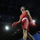 China's Ren Cancan walks to the ring to fight Russia's Elena Savelyeva during a women's flyweight 51-kg quarterfinal boxing match at the 2012 Summer Olympics, Monday, Aug. 6, 2012, in London. (AP Photo/Patrick Semansky)