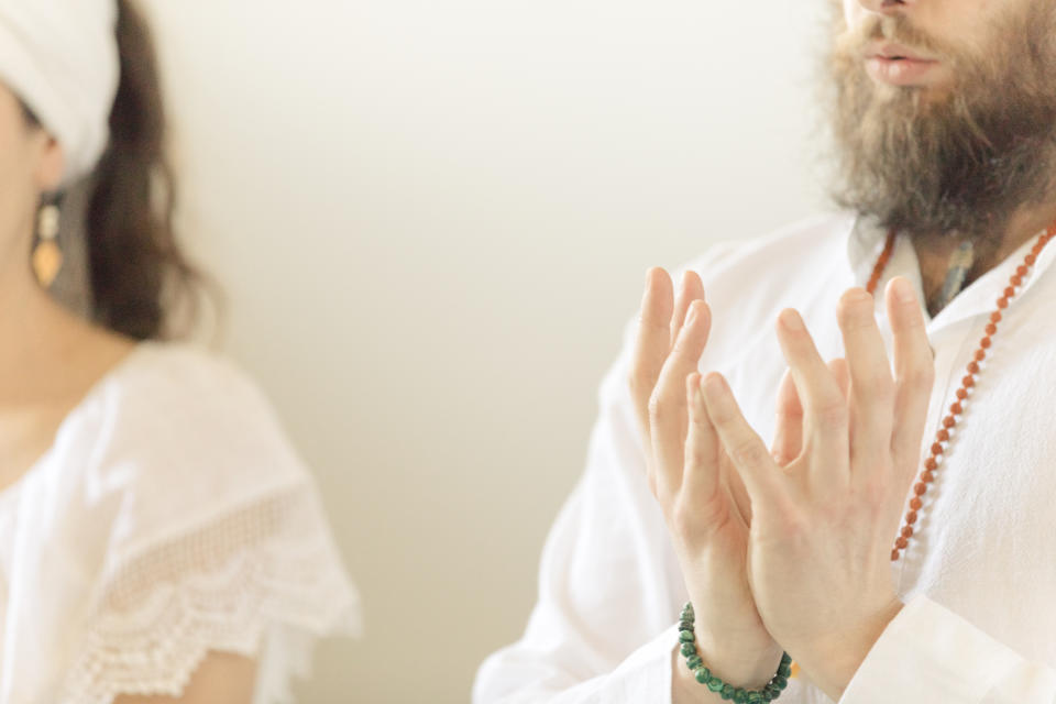 Kundalini. Couple practicing yoga. Lotus pose and meditation