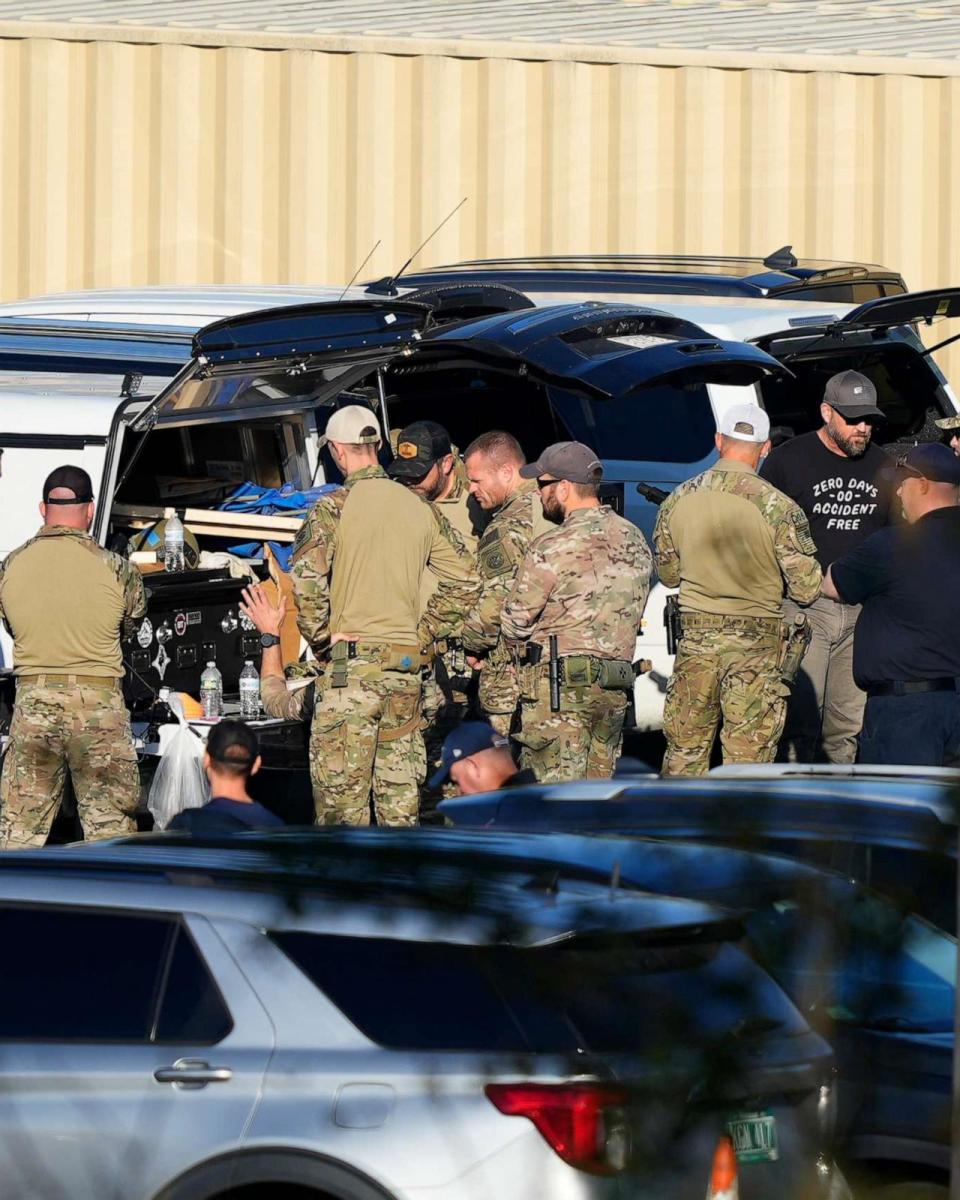 PHOTO: Law enforcement officers are staged in a school parking lot as a manhunt continues in the aftermath of a mass shooting in Lewiston, Maine, Friday, Oct. 27, 2023. (Matt Rourke/AP)