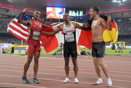 Aug 29, 2015; Beijing, China; Ashton Eaton (USA), left, poses with Damian Warner (CAN), center, and Rico Freimuth (GER) after winning the decathlon with a world record 9,045 points during the IAAF World Championships in Athletics at National Stadium. Mandatory Credit: Kirby Lee-USA TODAY Sports