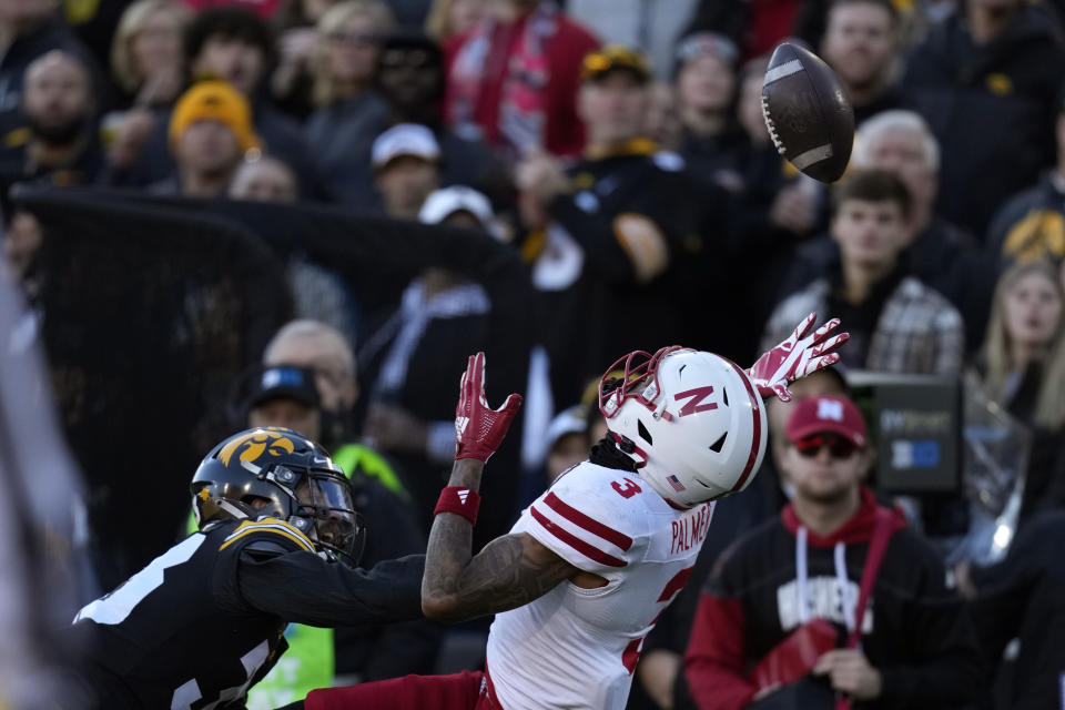 Nebraska wide receiver Trey Palmer (3) looks to catch a pass over Iowa defensive back Riley Moss, left, during the first half of an NCAA college football game, Friday, Nov. 25, 2022, in Iowa City, Iowa. The pass was incomplete. (AP Photo/Charlie Neibergall)