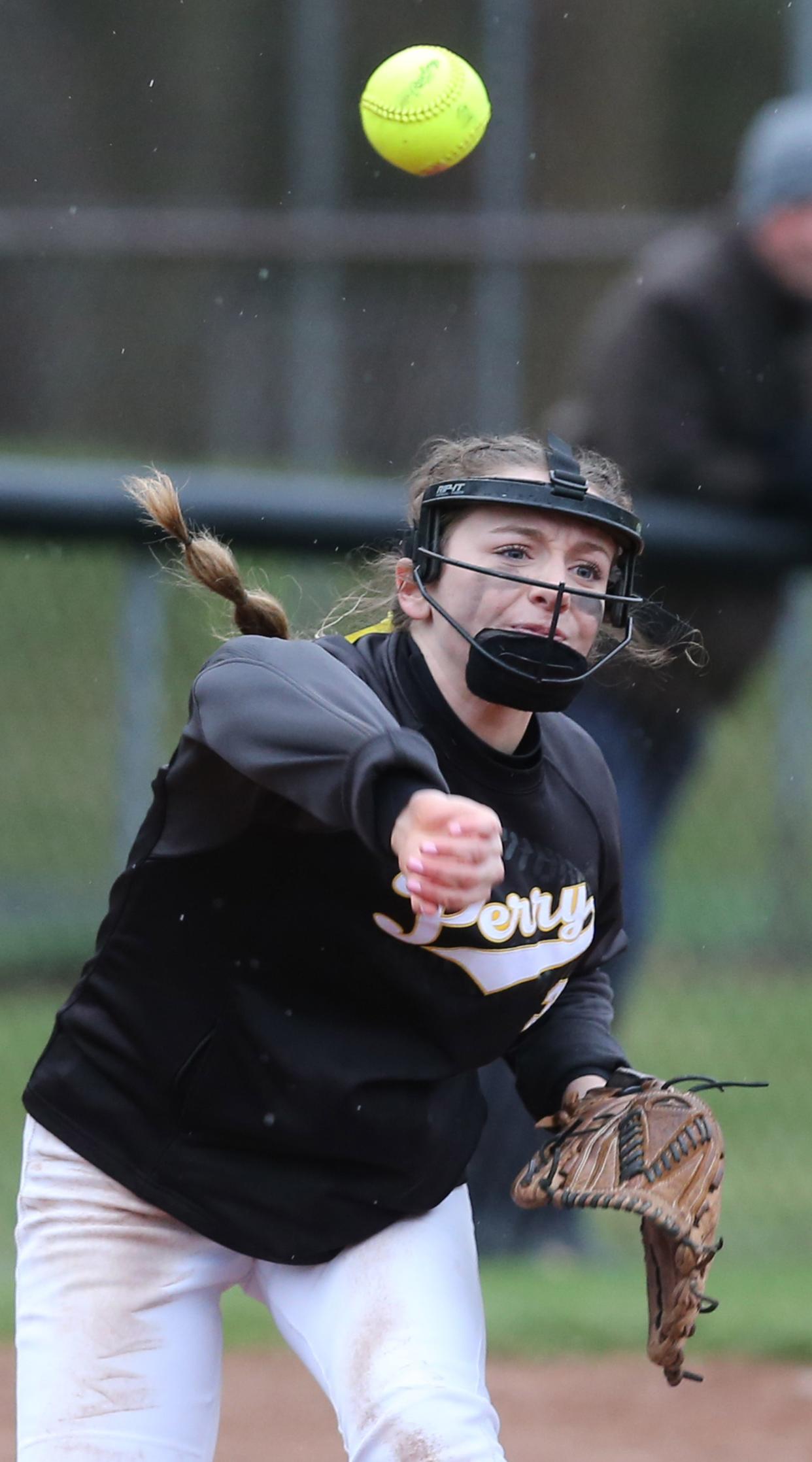 Marlee Pireu of Perry throws to get Lacie Quarles of Hoban out at first base during their game at Perry on Thursday, April 7, 2022. 