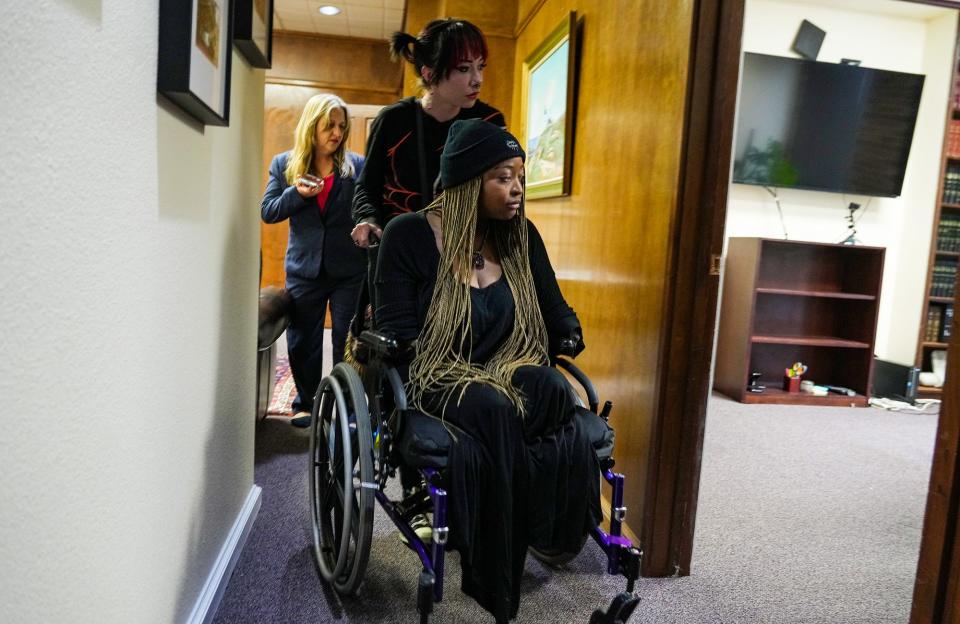 Autumn Lanning helps Whitney Mitchell, partner of slain protester Garrett Foster, into her attorney's office to discuss Gov. Abbott's request to the Texas pardons board that Daniel Perry, the man convicted of fatally shooting Foster, be pardoned.