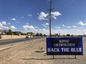 Sentiments in support of law enforcement are on prominent display on May 13, 2021, in Alamogordo, N.M., where the founder of the support group Cowboys for Trump is confronting federal charges for attending the Jan. 6 siege on the U.S. Capitol without entering the building. Otero County Commissioner and Cowboys for Trump Founder Couy Griffin is contending with federal criminal charges, a recall initiative and state probes into his finances as he fights for his political future. (AP Photo/Morgan Lee)