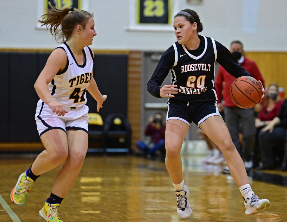 Roosevelt's Ari Crockett drives on Cuyahoga Falls' Laila Smith during the first half of their game Wednesday night at Cuyahoga Falls High School.