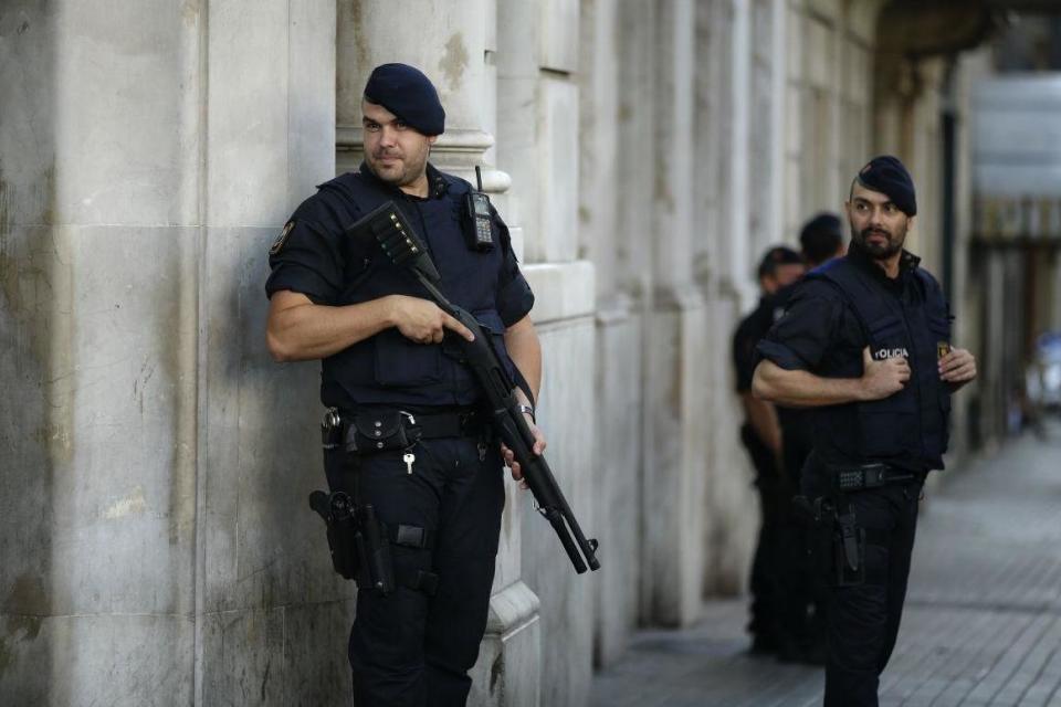Armed police officers patrol a street in Las Ramblas, Barcelona (AP)