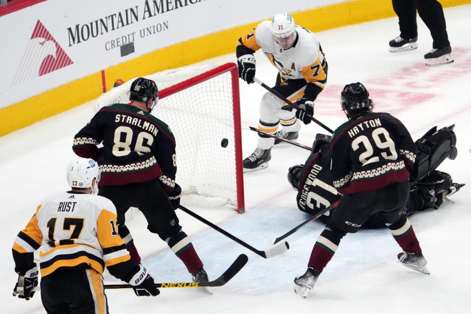 Mar 19, 2022; Glendale, Arizona, USA; Pittsburgh Penguins center Evgeni Malkin (71) scores a goal against Arizona Coyotes goaltender Scott Wedgewood (31) during the third period at Gila River Arena.