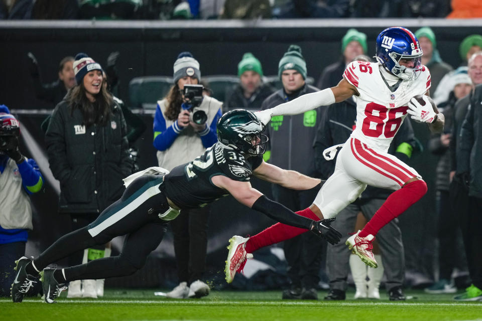 New York Giants wide receiver Darius Slayton scores past Philadelphia Eagles safety Reed Blankenship during the second half of an NFL football game Monday, Dec. 25, 2023, in Philadelphia. (AP Photo/Matt Slocum)