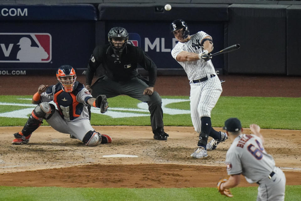 New York Yankees' Giancarlo Stanton follows through on a double during the fifth inning of a baseball game against the Houston Astros Tuesday, May 4, 2021, in New York. The Yankees won 7-3. (AP Photo/Frank Franklin II)