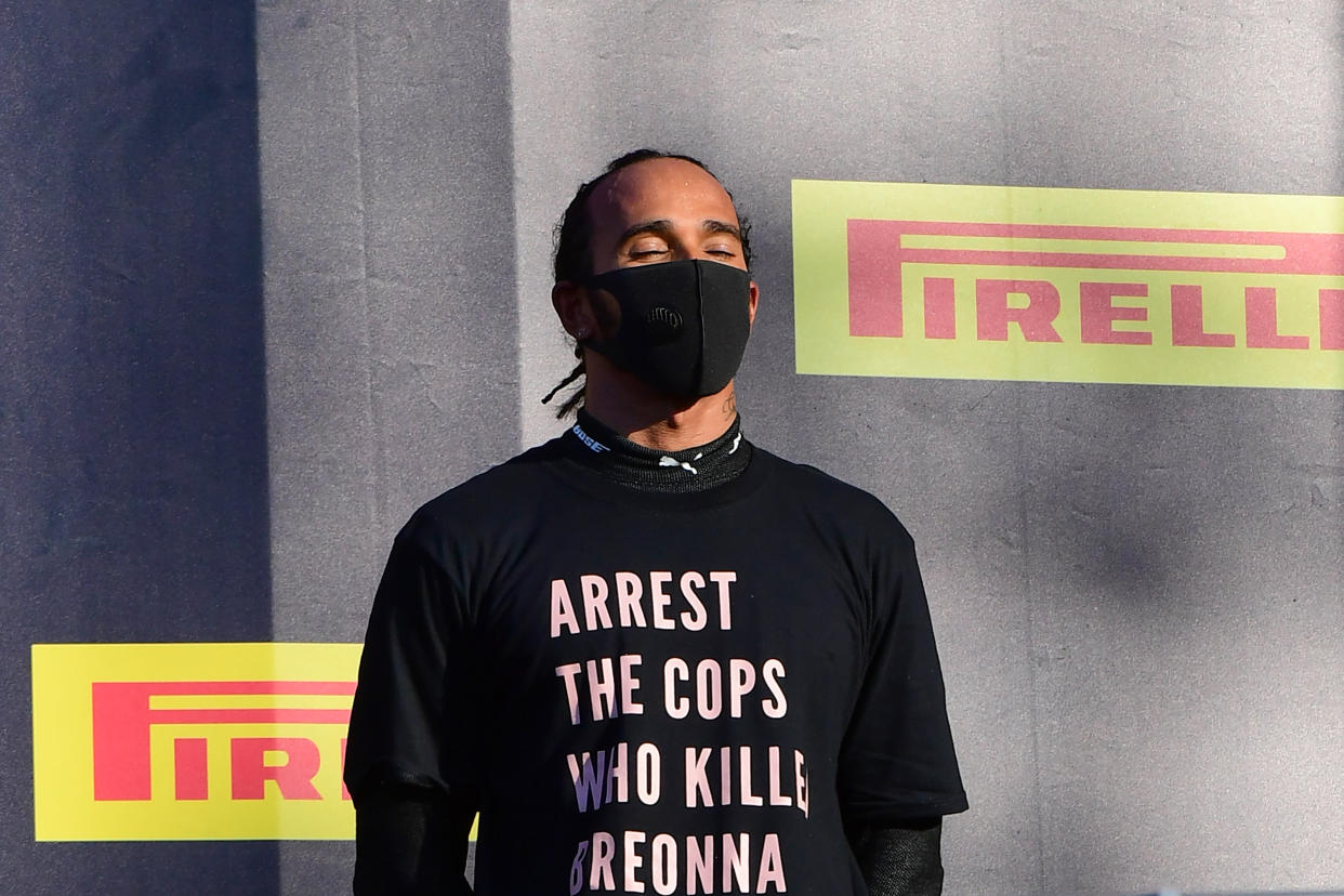 Winner Mercedes' British driver Lewis Hamilton reacts on the podium after the Tuscany Formula One Grand Prix at the Mugello circuit in Scarperia e San Piero on September 13, 2020. (Photo by JENNIFER LORENZINI / various sources / AFP) (Photo by JENNIFER LORENZINI/AFP via Getty Images)