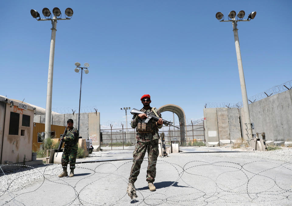 Image: Afghan soldiers stand guard at the gate of Bagram U.S. air base, on the day the last of American troops vacated it, Parwan province, Afghanistan (Mohammad Ismail / Reuters)