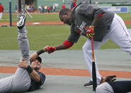 Boston Red Sox's David Ortiz, right, reaches down to greet a former teammate, New York Yankees' Jacoby Ellsbury, prior to a baseball game at Fenway Park in Boston, Tuesday, April 22, 2014. (AP Photo/Elise Amendola)