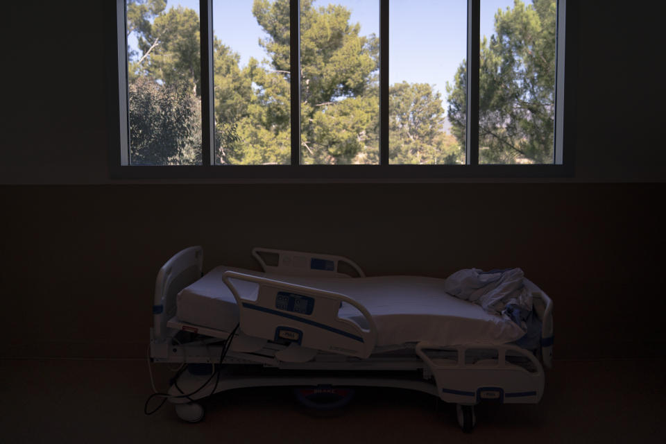 FILE - A hospital bed is seen in a COVID-19 unit at Providence Holy Cross Medical Center in the Mission Hills section of Los Angeles, Nov. 19, 2020. Roughly 84 million people are covered by Medicaid, the government-sponsored program that's grown by 20 million people since January 2020, just before the coronavirus pandemic hit. Now, as states begin checking everyone’s eligibility for Medicaid for the first time in three years, as many as 14 million people could lose access to that coverage. (AP Photo/Jae C. Hong, File)