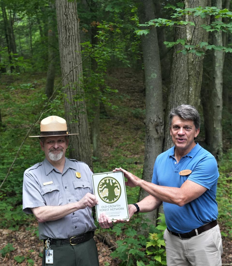 Brian Kane, Mid-Atlantic Regional Manager of the Old-Growth Forest Network, right, presents a designation sign to Delaware Water Gap National Recreation Area Superintendent Doyle Sapp, during a ceremony Thursday, June 29, at Hornbeck Creek. The other designated area is Mount Minsi in the southern end of the park.