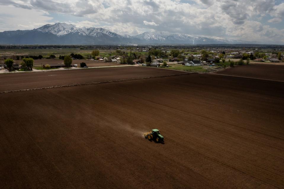 Ron Gibson, owner of Gibson’s Green Acres and president of the Utah Farm Bureau, drives a tractor while planting a field with corn in Ogden on Thursday, May 4, 2023. | Spenser Heaps, Deseret News