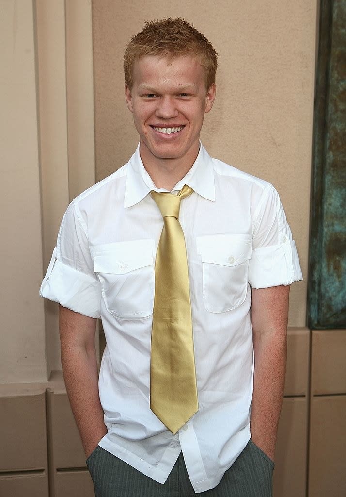 he's got spiky hair and wearing a large tie