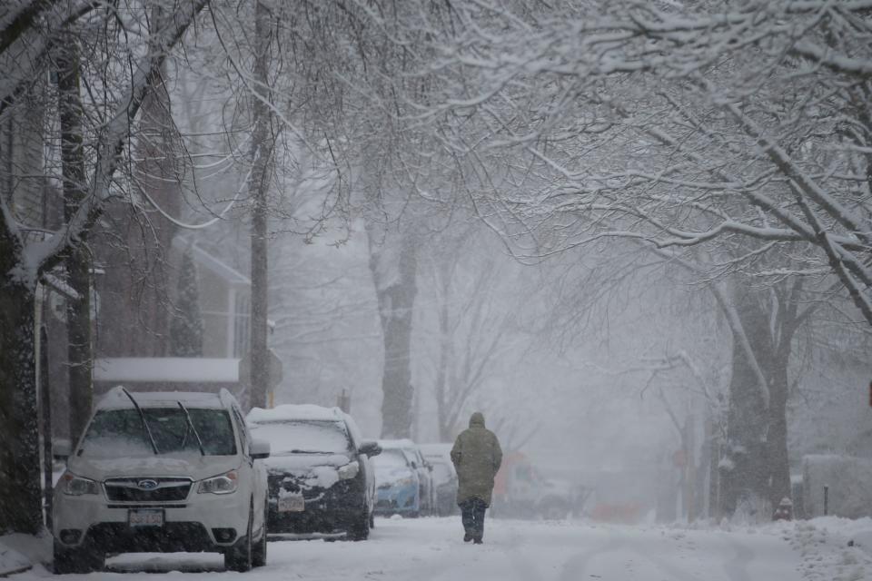 A man makes his way down Center Street in Fairhaven during last year's January snowfall.