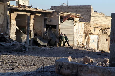 Residents inspect damage after airstrikes by pro-Syrian government forces in Anadan city, about 10 kilometers away from the towns of Nubul and Zahraa, Northern Aleppo countryside, Syria February 3, 2016. REUTERS/Abdalrhman Ismail