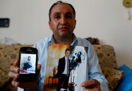 Tahir Kipcak shows photographs of his son Murat during an interview with Reuters in Istanbul, Turkey, May 31, 2016. REUTERS/Osman Orsal