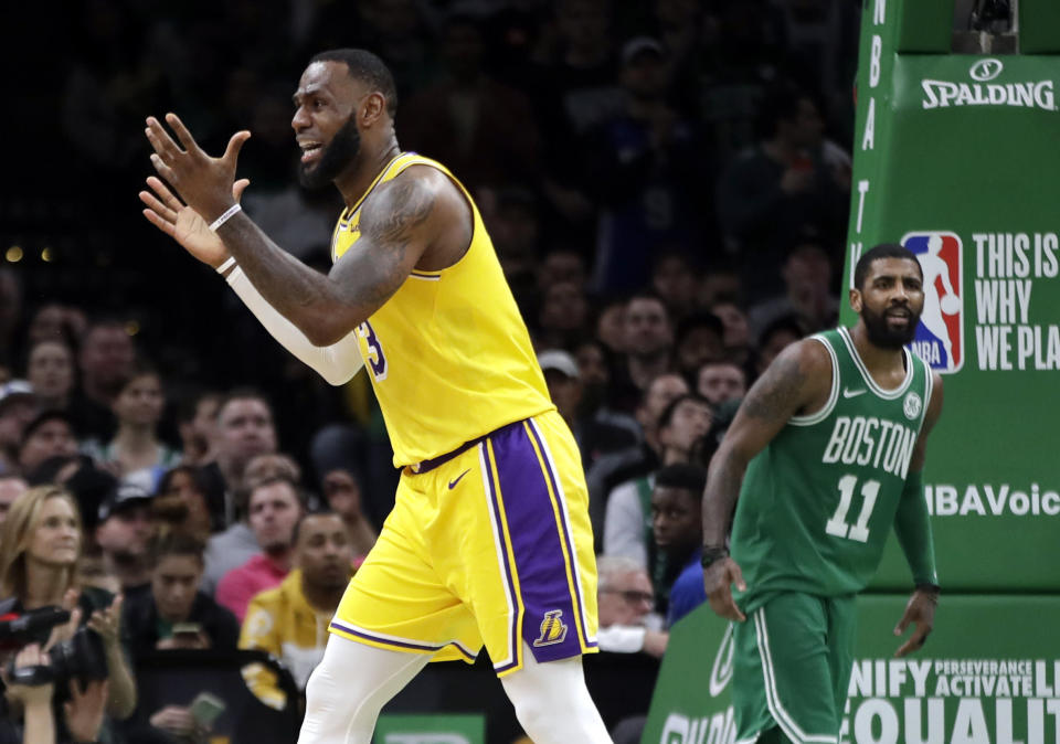 Los Angeles Lakers forward LeBron James (23) complains to the referee as Boston Celtics guard Kyrie Irving (11) looks on in the fourth quarter of an NBA basketball game, Thursday, Feb. 7, 2019, in Boston. The Lakers won 129-128. (AP Photo/Elise Amendola)