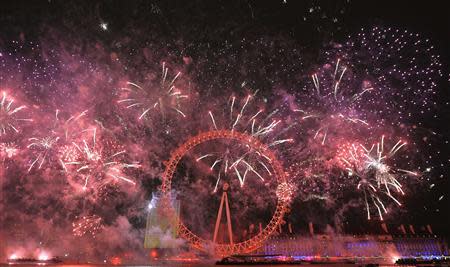 Fireworks explode around the London Eye wheel during New Year celebrations in central London January 1, 2014. REUTERS/Toby Melville