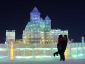 A couple shares an embrace in front of an ice sculpture at the Harbin Ice and Snow Sculpture Festival in the northern city of Harbin, Heilongjiang province January 5, 2014. The festival kicks off on Sunday. REUTERS/Kim Kyung-Hoon (CHINA - Tags: SOCIETY ENVIRONMENT TPX IMAGES OF THE DAY)