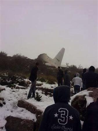 A crashed military plane is pictured in Oum El Bouaghi province, about 500km (311 miles) from the capital Algiers, February 11, 2014. REUTERS/Stringer