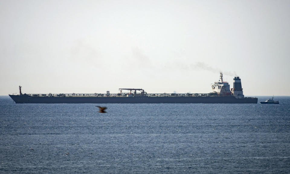 Grace 1 super tanker is anchored near a Royal Marine patrol vessel in the British territory of Gibraltar, Thursday, July 4, 2019. Spain's acting foreign minister says a tanker stopped off Gibraltar and suspected of taking oil to Syria was intercepted by British authorities after a request from the United States. (AP Photo/Marcos Moreno)