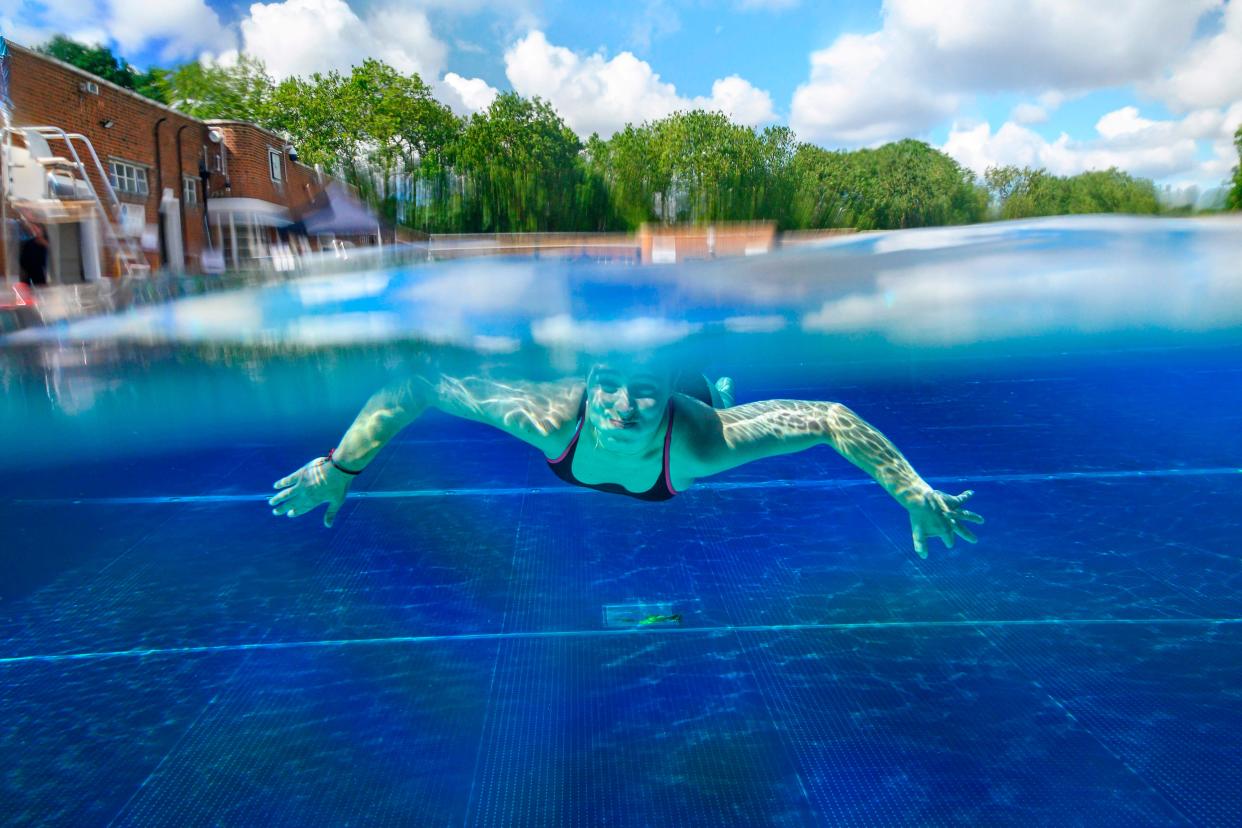 A person swims under water at Parliament Hill Lido in north London.  (AFP via Getty Images)