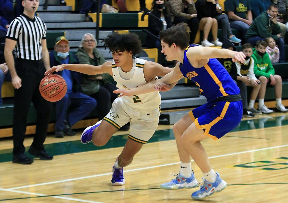 Salina South's Devin Myers (2) drives past Hutchinson's Garrett Robertson (11) during their game on Tuesday, Feb. 8, 2022. Hutchinson defeated Salina South 47-38.