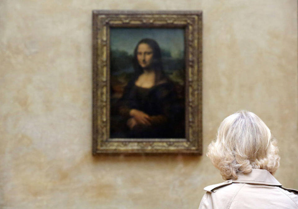 The Duchess of Cornwall checks if the Mona Lisa is stating at her during a visit in 2013 (Picture: PA)