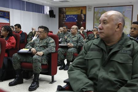 An image of Venezuela's late President Hugo Chavez is seen in a classroom during a lecture of the academic course, "Studies of the Thoughts of the Supreme Commander Hugo Chavez" in Caracas November 19, 2014. . REUTERS/Carlos Garcia Rawlins