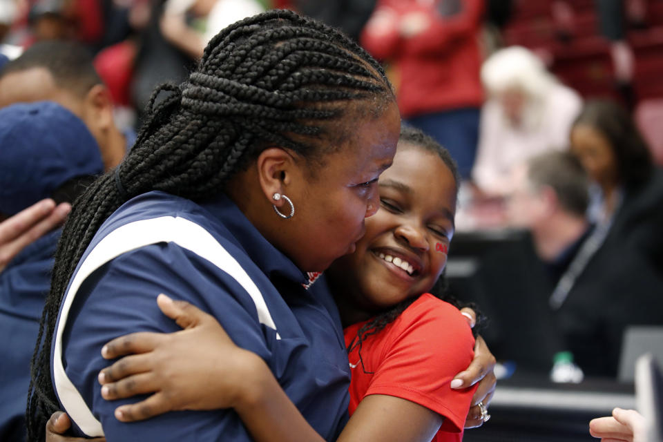 Mississippi head coach Yolett McPhee-McCuin kisses her daughter, Yasmine, after winning against Stanford after the second half of a second-round college basketball game in the women's NCAA Tournament, Sunday, March 19, 2023, in Stanford, Calif. (AP Photo/Josie Lepe)
