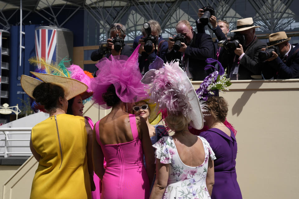 Racegoers pose for a photo, on the third day of the Royal Ascot horserace meeting, at Ascot Racecourse, in Ascot, England, Thursday, June 16, 2022. The third day is traditionally known as Ladies Day. (AP Photo/Alastair Grant)