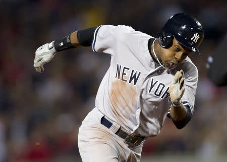 FILE PHOTO: New York Yankees' Curtis Granderson moves to third on a throwing error by Boston Red Sox starting pitcher Clay Buchholz during the first inning of their American League MLB baseball game against the Boston Red Sox at Fenway Park in Boston, Massachusetts September 15, 2013. REUTERS/Gretchen Ertl