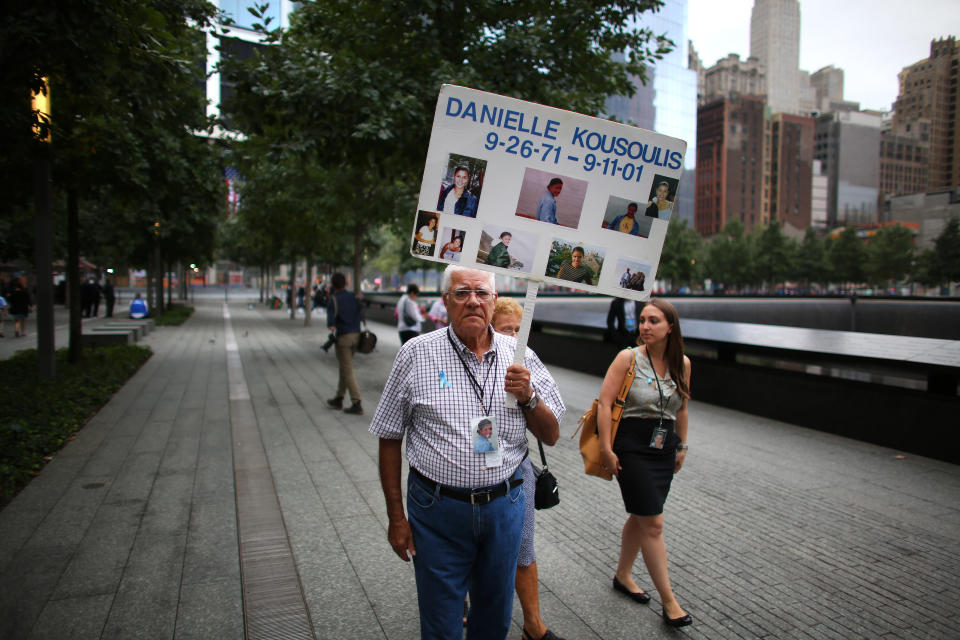 NEW YORK, NY - SEPTEMBER 11: A man carries a sign before the memorial observances held at the site of the World Trade Center before memorial observances are held at the site of the World Trade Center on September 11, 2014 in New York City. This year marks the 13th anniversary of the September 11th terrorist attacks that killed nearly 3,000 people at the World Trade Center, Pentagon and on Flight 93.  (Photo by Chang W. Lee-Pool/Getty Images)