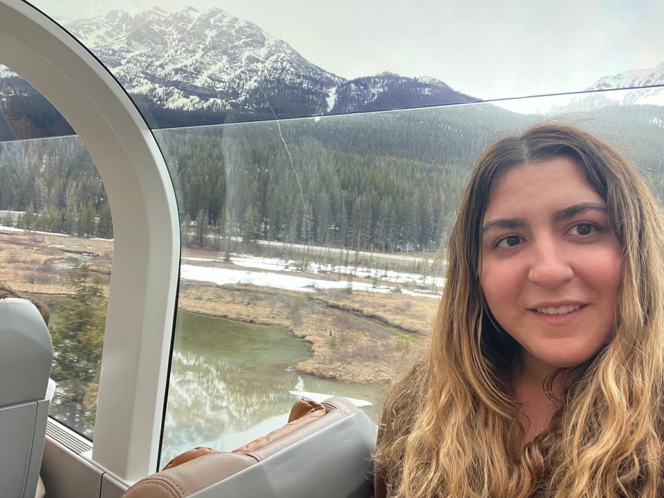 A selfie of the writer on the train with the Rocky Mountains in the background