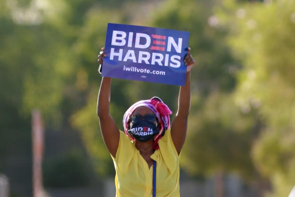 Supporter Stephanie Smith holds up a sign during a Biden-Harris voter mobilization drive-in event in Las Vegas on October 2, 2020. (Photo by Ronda Churchill / AFP) (Photo by RONDA CHURCHILL/AFP via Getty Images)