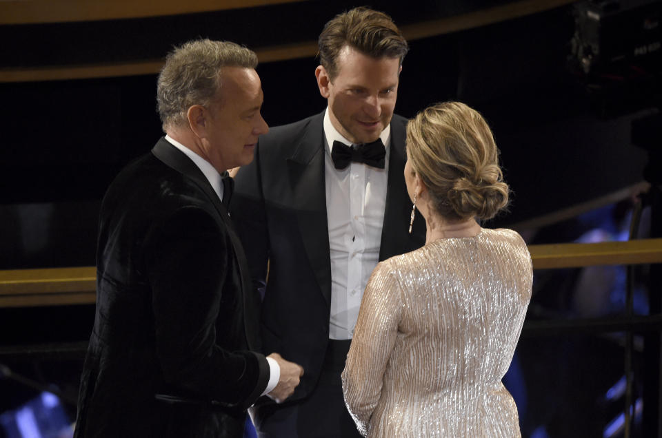 Tom Hanks, from left, Bradley Cooper and Rita Wilson speak in the audience at the Oscars on Sunday, Feb. 9, 2020, at the Dolby Theatre in Los Angeles. (AP Photo/Chris Pizzello)