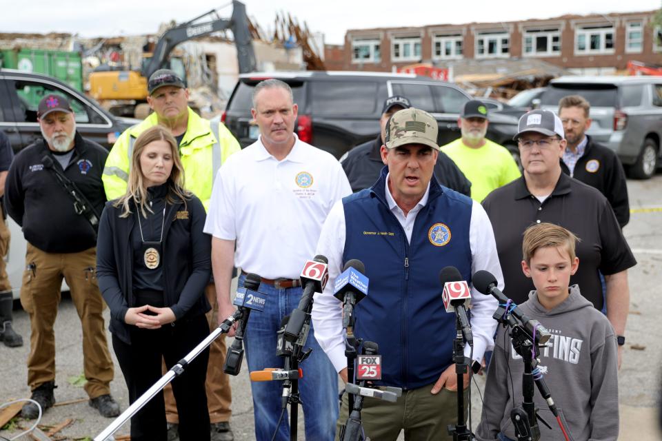 Gov. Kevin Stitt speaks beside his son Houston during a press conference in Sulphur, Okla., Sunday, April 28, 2024. Sulphur was hit by a tornado the night before killing one person.
