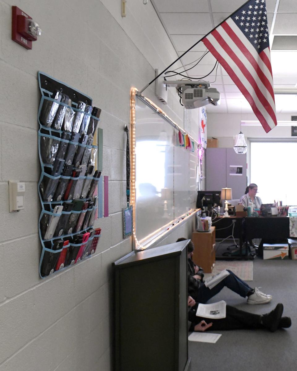 A new policy this school year requires Northwest High School students to place their cellphones in a hanging pouch at the start of class.