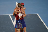 Belinda Bencic, of Switzerland, is hugged by Marketa Vondrousova, of the Czech Republic, following the women's gold medal match of the tennis competition at the 2020 Summer Olympics, Saturday, July 31, 2021, in Tokyo, Japan. Bencic won the match. (AP Photo/Seth Wenig)