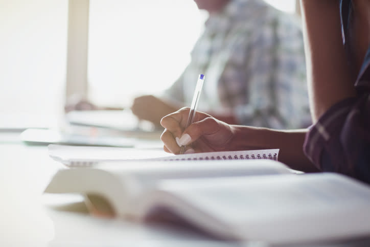 Student taking notes in class