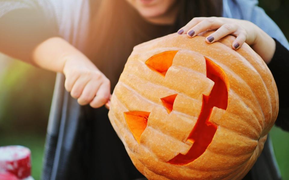 Halloween 2021 trick-or-treating fancy dress costumes carving pumpkins October 31 - iStockphoto