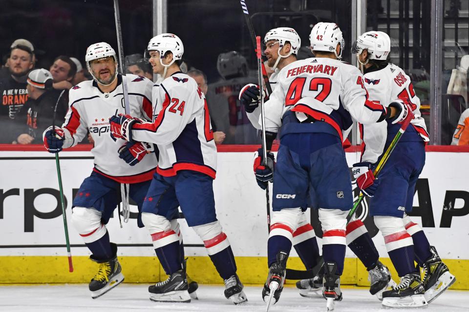 Washington Capitals forward Alex Ovechkin, left, celebrates after scoring his 31st goal of the season during the regular-season finale.