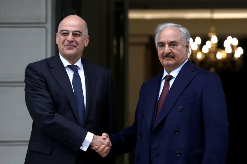 Greek Foreign Minister Nikos Dendias welcomes Libya's commander Khalifa Haftar at the Foreign Ministry in Athens