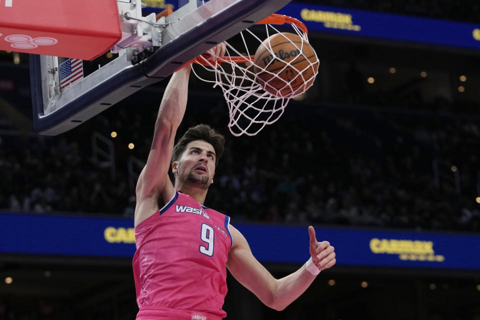 Washington Wizards forward Deni Avdija (9) dunk the ball during the first half of an NBA basketball game against the Denver Nuggets Wednesday, March 22, 2023, in Washington. (AP Photo/Carolyn Kaster)